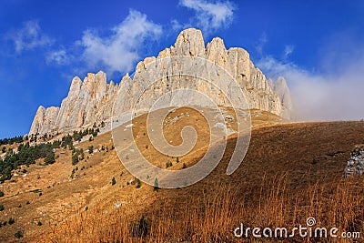 Rocky bastion of Bolshoy Big Tkhach mountain peak in Caucasus Mountains at autumn. Scenic blue sky landscape Stock Photo