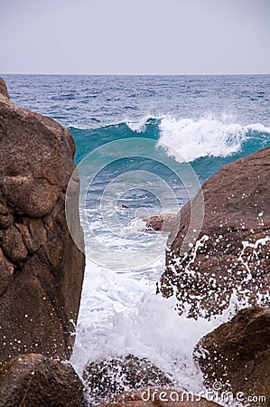 Rocky Beach and Beachcomber Stock Photo