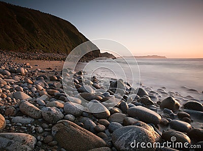 Rocky beach at sunset. Stock Photo