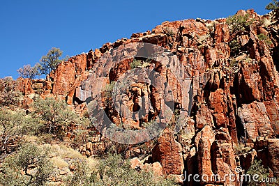 Rocky cliff with trees and blue sky in outback Australia Stock Photo
