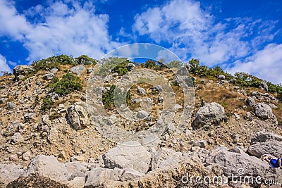 Rocky climb up the mountain and blue sky with clouds Stock Photo