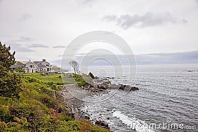 Rocky coast and beach house in York Maine Stock Photo