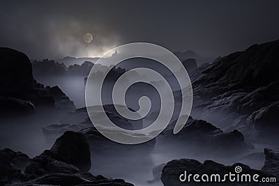 Rocky coast in a full moon night Stock Photo