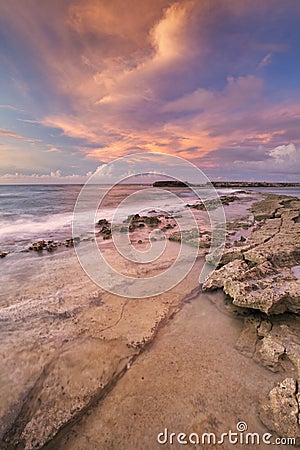 Rocky coast on the island of CuraÃ§ao at sunset Stock Photo