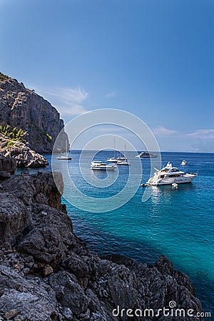 Rocky coast on Mallorca with boats Stock Photo