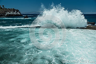 Rocky coastline and big wave breaking on natural swimming pool of Tenerife Island Stock Photo