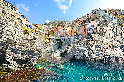 The rocky coastline and swimming bay on the Ligurian Coast of Italy at the village of Manarola, Italy, part of the Cinque Terre Editorial Stock Photo