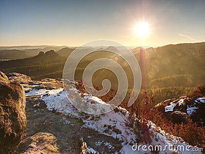 Rocky hill above inverse mist. Winter cold weather in mountains Stock Photo