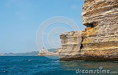 The rocky landscape of Bonifacio coast with La Madonetta lighthouse, Corsica, France Stock Photo