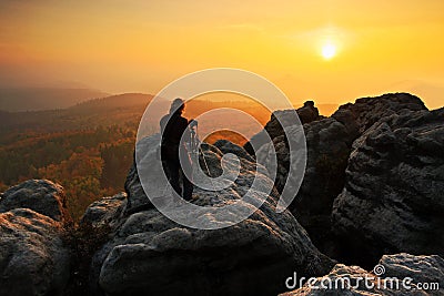 Rocky landscape with photographer during autumn. Beautiful landscape with stone. Sunset in czech national park Ceske Svycarsko. Mi Stock Photo