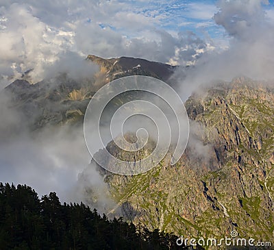 rocky mountain chain in dense clouds Stock Photo