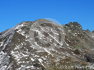 Rocky mountain peak Piz Arpschella (3031 m) in the massif of the Albula Alps above the Swiss road pass Fluela Stock Photo