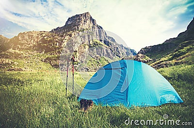 Rocky Mountains Landscape and tent camping with trekking poles and boots Travel Lifestyle Stock Photo