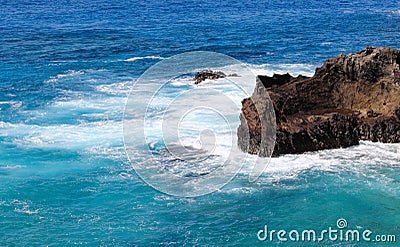Rocky Outcrop in Hawaiian Blue Waters Stock Photo