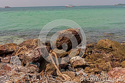 A rocky part of the beach in Koh Larn Stock Photo