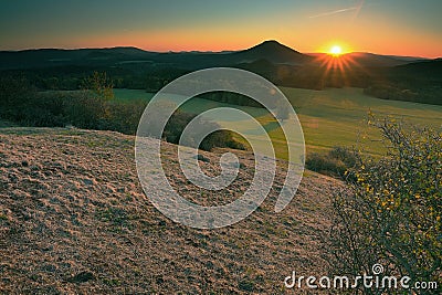 Rocky peak with daybreak. Full moon night ends and sun appeared Stock Photo