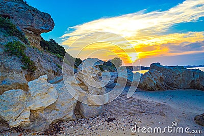 Rocky sandy Chalkidiki beach Greece at sunset Stock Photo