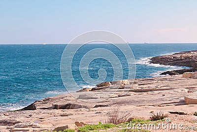 Rocky seashore line with no people in Marsaskala, Malta. Mediterranean sea Stock Photo