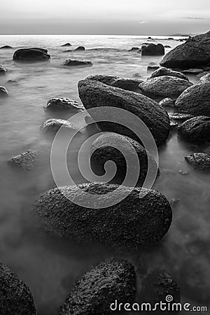 Rocky seashore in sunset black and white Stock Photo