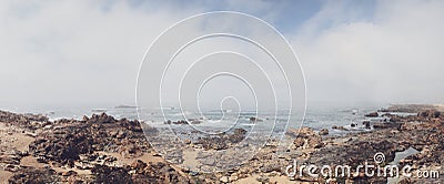 Rocky shore with a cloudy view over atlantic sea Stock Photo