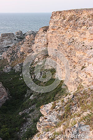 Rocky shores of the Dzhangul landslide coastline in the rays of the setting sun Stock Photo