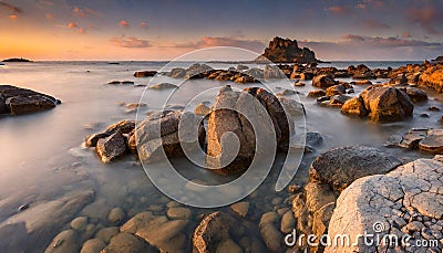 Rocky shores at the sea sunset light Stock Photo