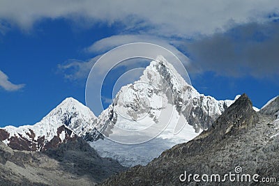 Rocky and snow ice covered mountain range of Cordillera Blanca in the Andes Stock Photo