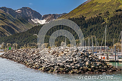 Rocky wave breaker as protection of Seward port, Alaska, USA Stock Photo