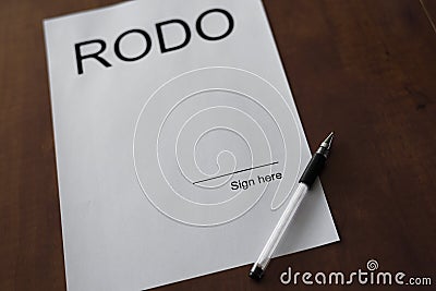 Rodo word on white paper with pen od wood desk. Stock Photo