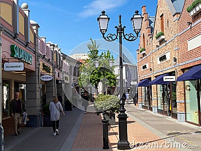 View on exterior shopping street in summer with blue sky Editorial Stock Photo