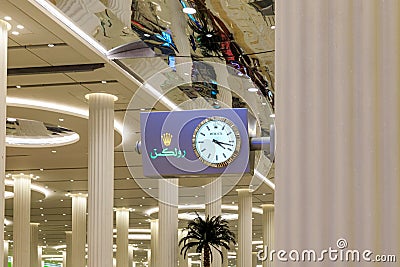 Rolex large wall clock in the baggage claim area at the Dubai International Airport in Dubai city, United Arab Emirates Editorial Stock Photo