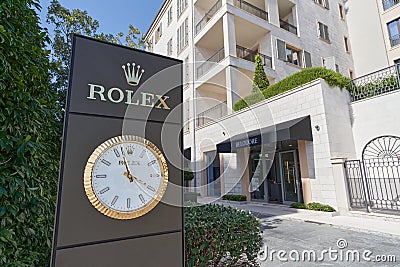 TIVAT, MONTENEGRO - JULY 15, 2021: Rolex signboard stand with a large watch in a luxury residential area in Porto Editorial Stock Photo
