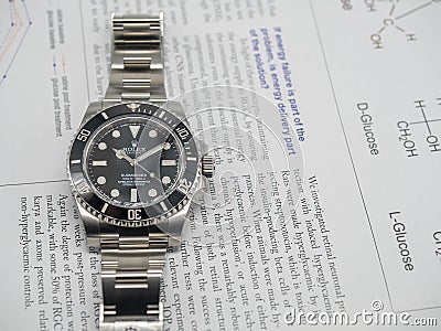 Rolex submariner on English paper Editorial Stock Photo