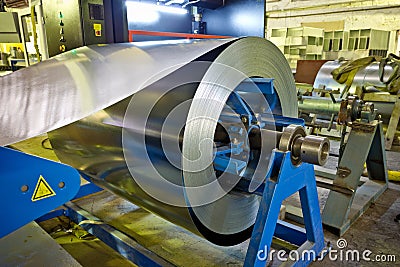 Roll of galvanized steel sheet for manufacturing metal pipes and tubes in the factory Stock Photo