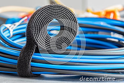 Roll of hook and loop, velcro tape with bundle of cables, electrical installations Stock Photo