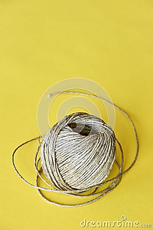 Roll of natural sisal twine on yellow Stock Photo