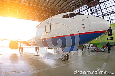 Roll-out of the aircraft from the hangar by a aerodrome tractor, after repair. Stock Photo