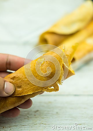Roll pancake stuffed with it`s Thai in hand Stock Photo