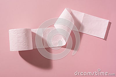 A roll of pink toilet paper on a pink background Stock Photo