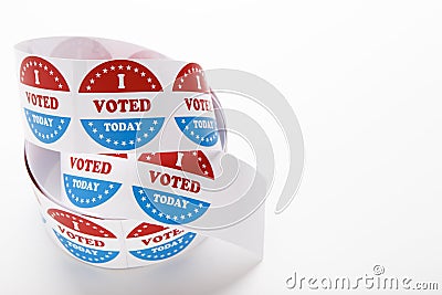 Roll of red white and blue I voted stickers with American flag Stock Photo