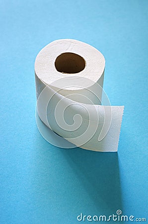 Roll of toilet paper on the blue background. Tissue for use in the toilet room, used for cleaning the dirt in the bathroom. Stock Photo