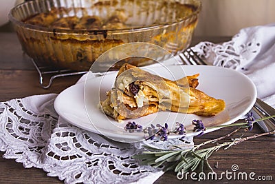 Rolled, baked pancakes stuffed with sweet cheese. Stock Photo