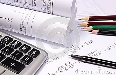 Rolled electrical diagrams, calculator and mathematical calculations Stock Photo