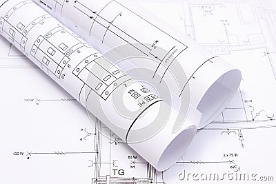 Rolled electrical diagrams on construction drawing of house Stock Photo