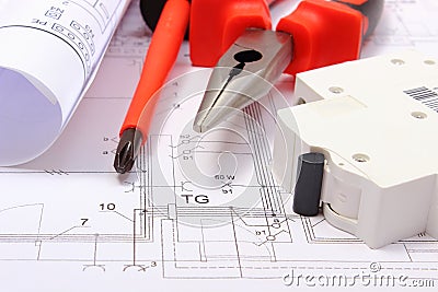 Rolled electrical diagrams, electric fuse and work tools on construction drawing of house Stock Photo