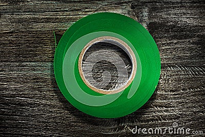 Rolled electrical tape on wooden board Stock Photo