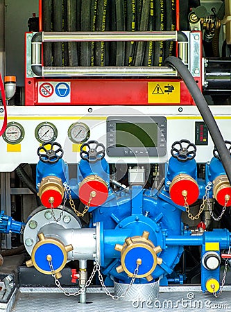 Rolled hose and pump on a fire engine Stock Photo