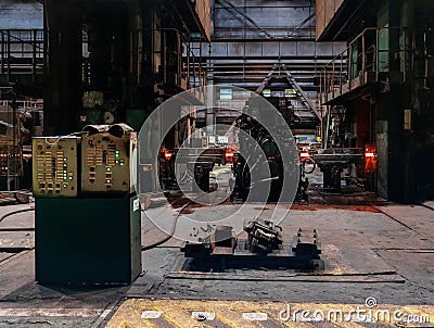Rolled metal factory hot steel bar on conveyor moving through rollers Stock Photo