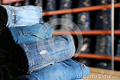 Rolled modern jeans in shop, closeup Stock Photo