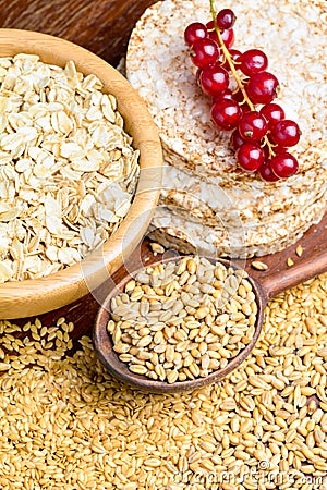 Rolled oats, golden linseeds (flax seeds), whole wheat grains and rice cakes Stock Photo